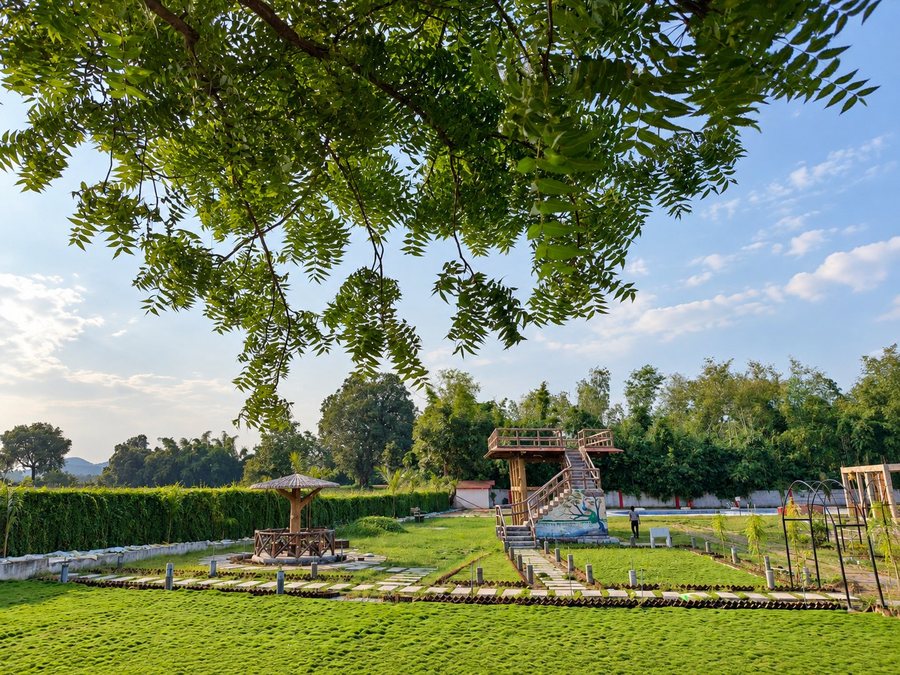 The resort lawn with a thatched gazebo and the raised viewing deck beyond