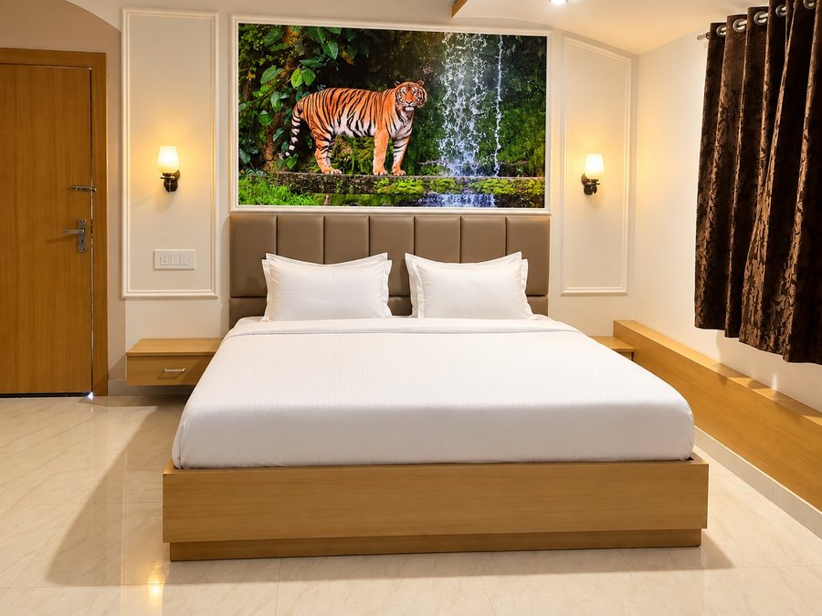 Premium room with a king bed, wall sconces and a framed tiger mural above the headboard